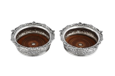 Lot 611 - A pair of George III sterling silver wine coasters, London 1818 by Thomas Robins