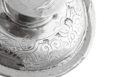 Lot 692 - An Elizabeth I sterling silver communion cup cover (paten), London 1569, makers mark a millrind in a shaped cartouche (unidentified)