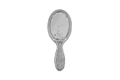 Lot 129 - An early 20th century Anglo - Indian unmarked silver hand mirror, Cutch circa 1910