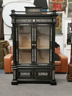 Lot 174 - A 19TH CENTURY ITALIAN EBONISED AND BONE INLAID BREAKFRONT DISPLAY CABINET
