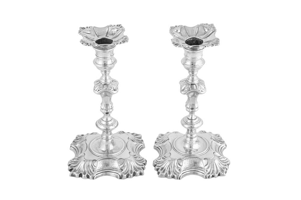 Lot 672 - A pair of George II sterling silver candlesticks, London 1744/1745 by John Cafe