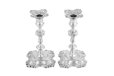 Lot 672 - A pair of George II sterling silver candlesticks, London 1744/1745 by John Cafe
