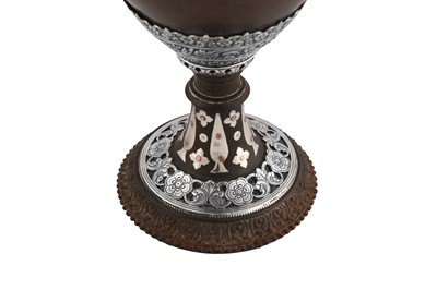 Lot 136 - A mid-19th century Anglo - Indian unmarked silver mounted coconut cup, Cutch circa 1860