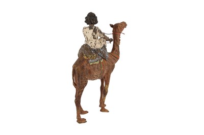 Lot 677 - A COLD-PAINTED BRONZE FIGURE OF A NUBIAN BOY RIDING AN ARABIAN CAMEL (DROMEDARY)