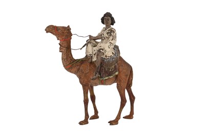 Lot 677 - A COLD-PAINTED BRONZE FIGURE OF A NUBIAN BOY RIDING AN ARABIAN CAMEL (DROMEDARY)