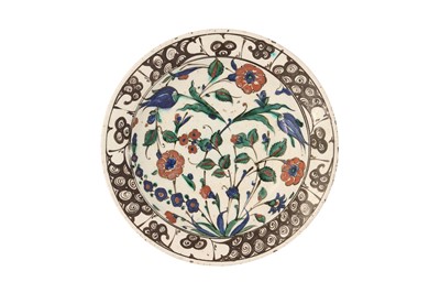 Lot 720 - AN IZNIK POTTERY DISH WITH FLORAL DESIGN