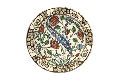 Lot 719 - AN IZNIK POTTERY DISH WITH A SAZ LEAF AND RED CARNATIONS