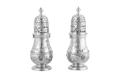 Lot 680 - A pair of Queen Anne Britannia standard silver pepper casters, London probably 1710 probably by Christopher Canner I