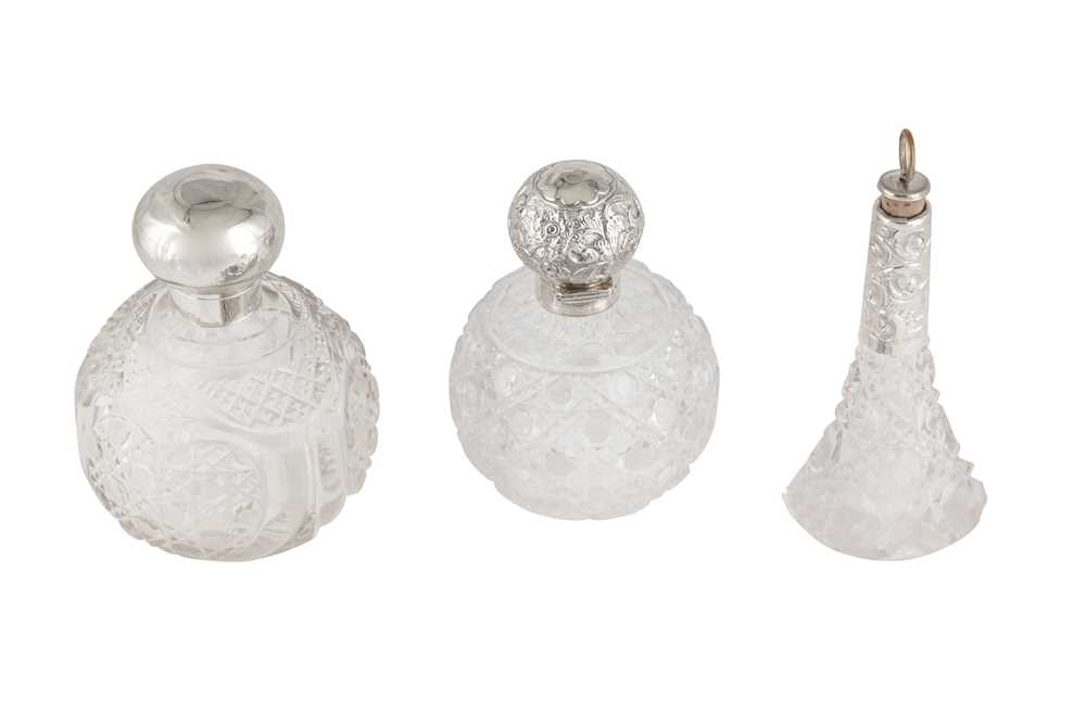 Lot 16 - THREE VICTORIAN AND LATER STERLING SILVER MOUNTED CUT GLASS SCENT BOTTLES