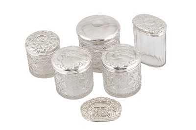 Lot 12 - A MIXED GROUP OF FIVE EDWARDIAN AND LATER STERLING SILVER TOPPED DRESSING TABLE JARS