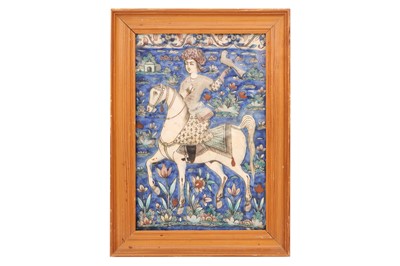 Lot 598 - A QAJAR MOULDED POTTERY TILE WITH A FALCONER