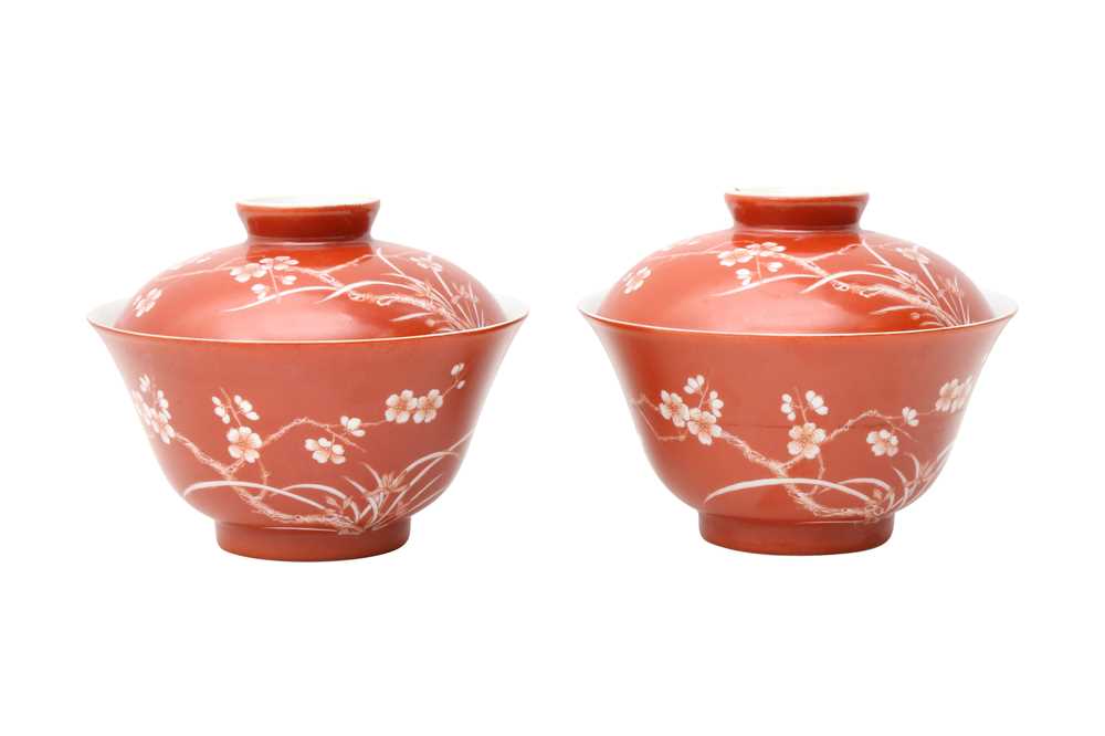 Lot 211 - A PAIR OF CHINESE CORAL-GROUND 'PRUNUS' BOWLS AND COVERS