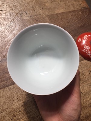 Lot 211 - A PAIR OF CHINESE CORAL-GROUND 'PRUNUS' BOWLS AND COVERS