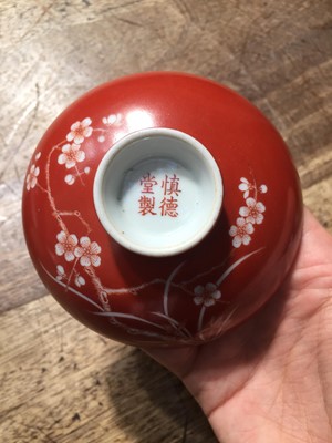 Lot 211 - A PAIR OF CHINESE CORAL-GROUND 'PRUNUS' BOWLS AND COVERS