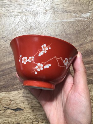 Lot 211 - A PAIR OF CHINESE CORAL-GROUND 'PRUNUS' BOWLS AND COVERS