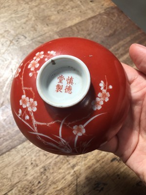 Lot 211 - A PAIR OF CHINESE CORAL-GROUND 'PRUNUS' BOWLS AND COVERS