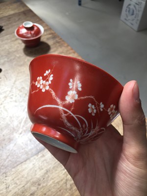 Lot 211 - A PAIR OF CHINESE CORAL-GROUND 'PRUNUS' BOWLS AND COVERS