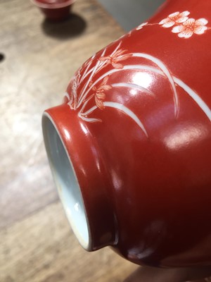 Lot 211 - A PAIR OF CHINESE CORAL-GROUND 'PRUNUS' BOWLS AND COVERS