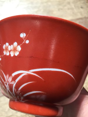 Lot 211 - A PAIR OF CHINESE CORAL-GROUND 'PRUNUS' BOWLS AND COVERS