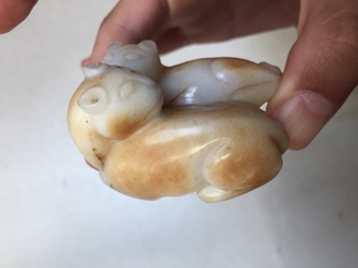 Lot 546 - A CHINESE CREAM JADE 'CATS' CARVING
