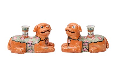 Lot 176 - A PAIR OF CHINESE FAMILLE ROSE 'DOG' CANDLE HOLDERS.