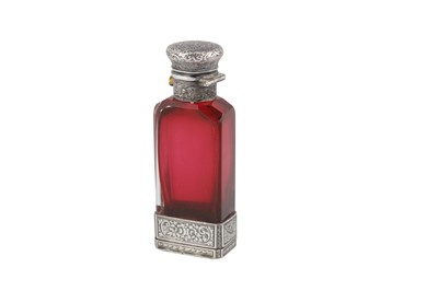 Lot 325 - A Victorian sterling silver mounted ruby glass scent bottle combination vinaigrette, Birmingham 1877 by Fredrick Marston
