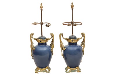 Lot 472 - A PAIR OF POWDER BLUE PORCELAIN AND ORMOLU MOUNTED TABLE LAMPS