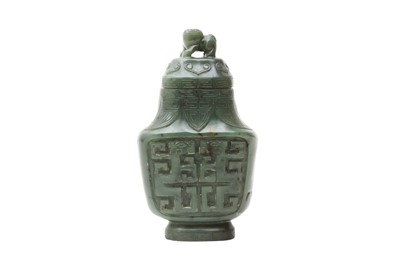 Lot 296 - A CHINESE SPINACH-GREEN JADE ARCHAISTIC VASE AND COVER