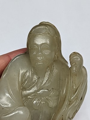 Lot 311 - A CHINESE PALE CELADON JADE FIGURE OF A SAGE