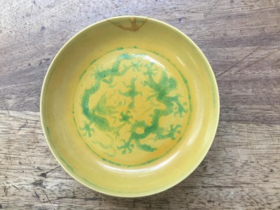 Lot 528 - A CHINESE GREEN AND YELLOW-GLAZED 'DRAGON' DISH.