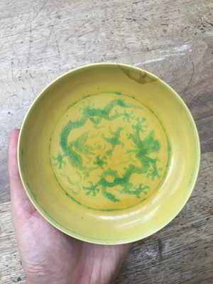 Lot 528 - A CHINESE GREEN AND YELLOW-GLAZED 'DRAGON' DISH.