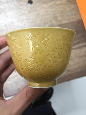 Lot 30 - A CHINESE YELLOW-GLAZED CUP AND AN INCISED 'DRAGON' CUP.