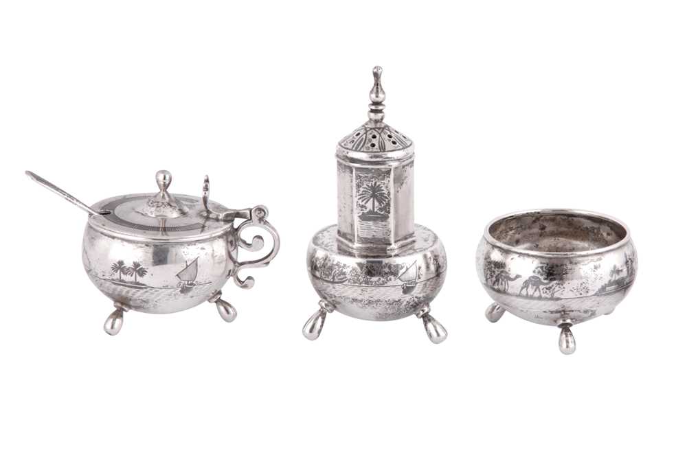 Lot 673 - AN IRAQI SILVER AND NIELLO THREE-PIECE CRUET SET