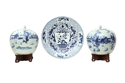 Lot 396 - A NEAR-PAIR OF CHINESE CELADON-GROUND JARS AND COVERS AND A BLUE AND WHITE DISH.
