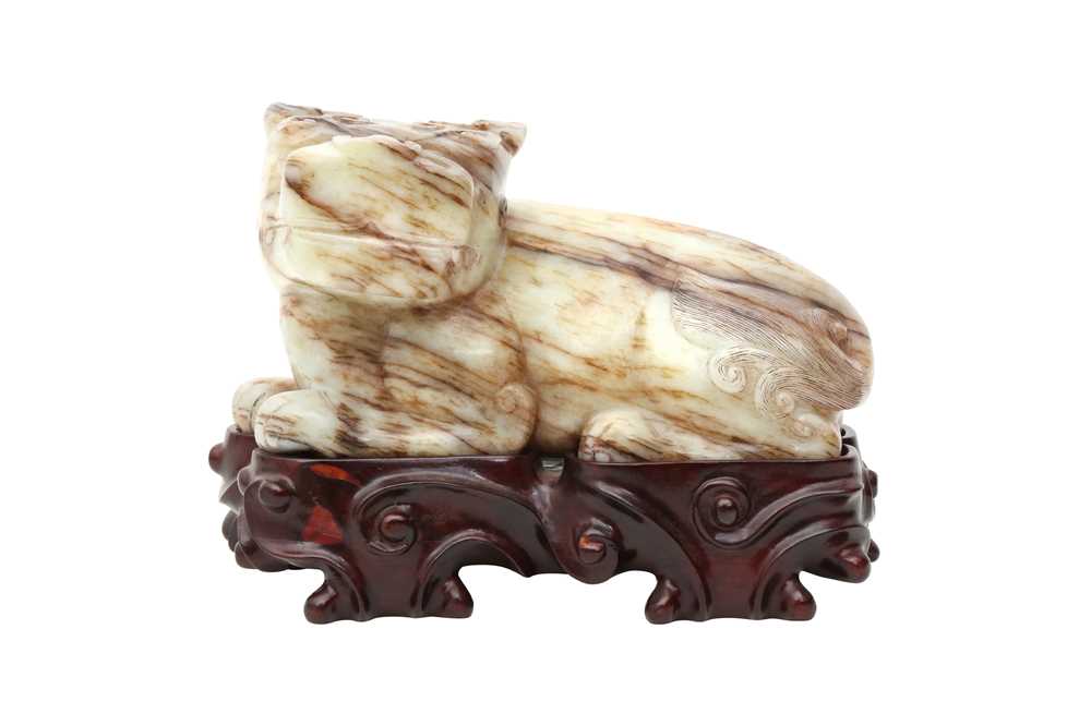 Lot 307 - A CHINESE PALE CELADON JADE 'MYTHICAL BEAST' CARVING