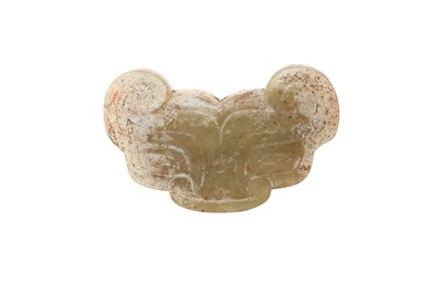 Lot 38 - A CHINESE PALE CELADON JADE 'ARCHAISTIC MASK' PENDANT.
