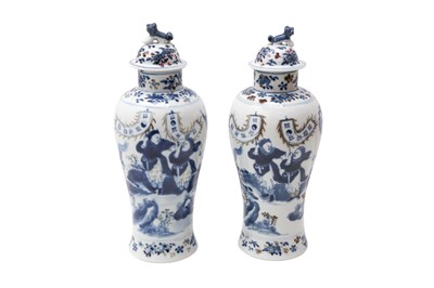 Lot 110 - A PAIR OF CHINESE BLUE AND WHITE AND UNDERGLAZE RED 'WARRIORS' VASES AND COVERS.