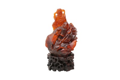 Lot 40 - A CHINESE AMBER 'IMMORTALS' CARVING.