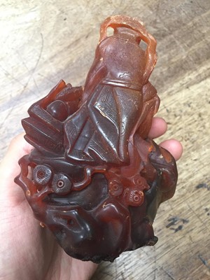 Lot 324 - A CHINESE AMBER 'IMMORTALS' CARVING