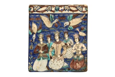 Lot 57 - A QAJAR MOULDED POLYCHROME-PAINTED POTTERY TILE WITH KNEELING PRINCES