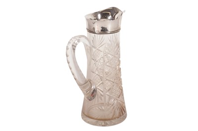 Lot 121 - A GEORGE V CUT GLASS CLARET JUG, WITH A STERLING SILVER RIM