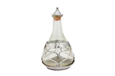 Lot 536 - An Edwardian ‘Arts and Crafts’ sterling silver mounted glass oil or vinegar bottle, London 1904 by Omar Ramsden and Alwyn Carr