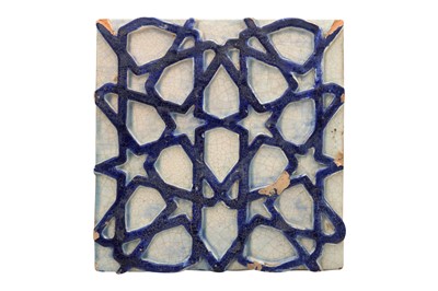Lot 485 - A MOULDED POTTERY TILE WITH A GEOMETRIC STAR PATTERN
