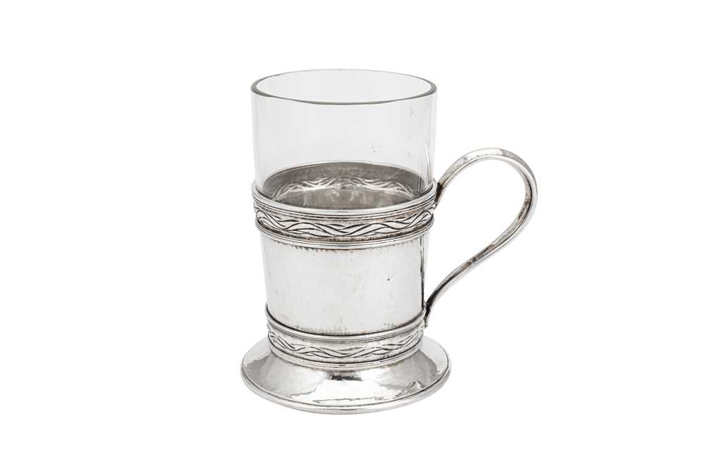 Lot 542 - A George V ‘Arts and Crafts’ sterling silver tea glass holder, London 1930 by Omar Ramsden (1873-1939)