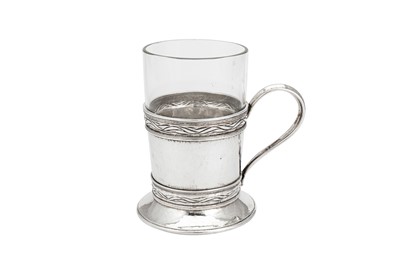 Lot 542 - A George V ‘Arts and Crafts’ sterling silver tea glass holder, London 1930 by Omar Ramsden (1873-1939)