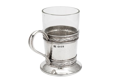 Lot 542 - A George V ‘Arts and Crafts’ sterling silver tea glass holder, London 1930 by Omar Ramsden (1873-1939)