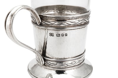 Lot 542 - A George V ‘Arts and Crafts’ sterling silver tea glass holder, London 1930 by Omar Ramsden (1873-1939)