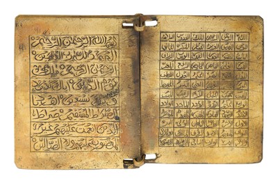 Lot 403 - AN ENGRAVED BRASS QUR'ANIC BOOK WITH MATCHING CASE