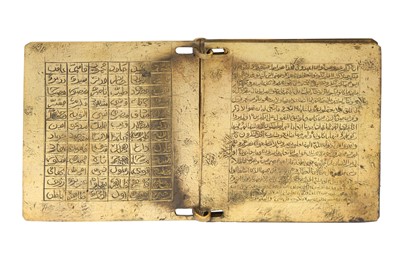 Lot 403 - AN ENGRAVED BRASS QUR'ANIC BOOK WITH MATCHING CASE