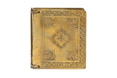 Lot 403 - AN ENGRAVED BRASS QUR'ANIC BOOK WITH MATCHING CASE